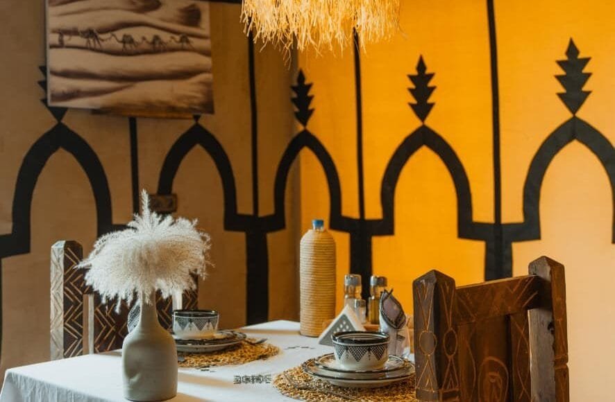 Romantic candlelit dinner setup at Dihya — honeymoon luxury desert camp Morocco