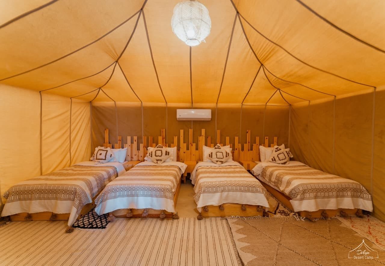 Standard luxury tent at Dihya Desert Camp — 4 single beds, AC, real linens